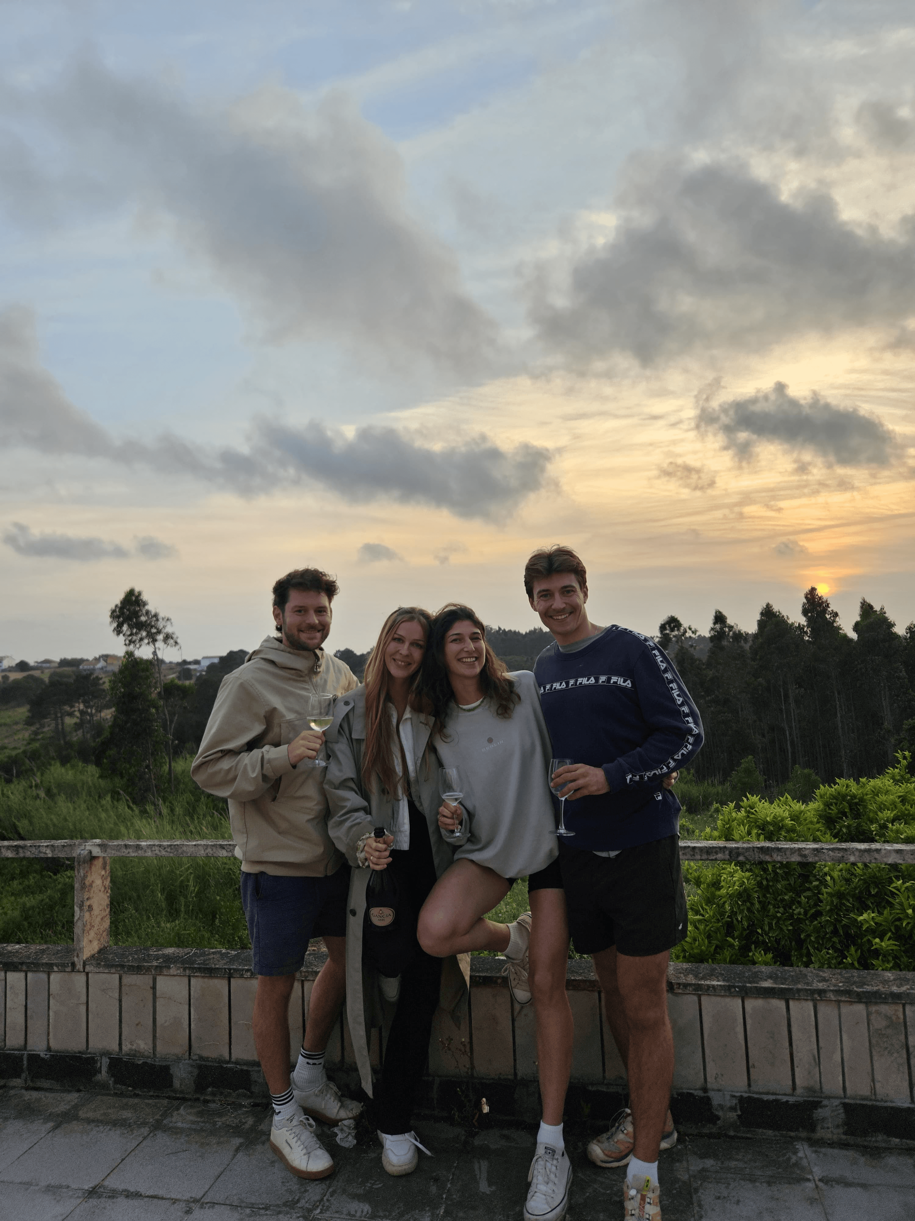Four Nuara friends together on the terrace at sunset.